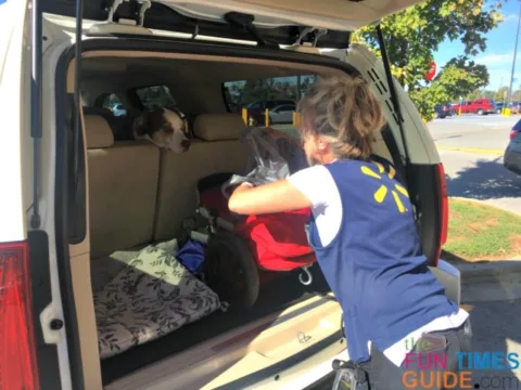 walmart associate loading groceries into the back of my suv